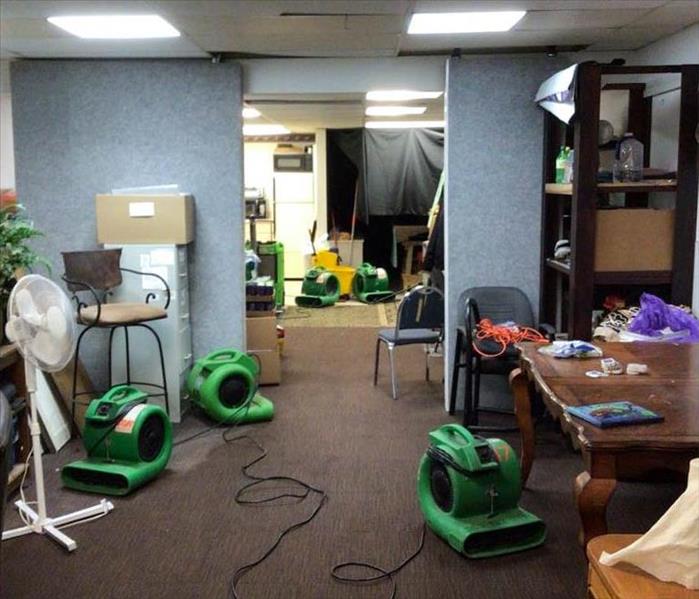 Office after water damage with fans drying the area